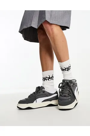 PUMA 180 trainers in dark and white