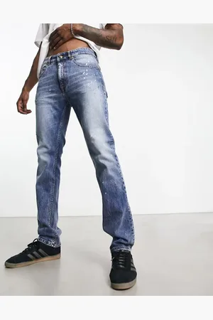 VERSACE Distressed slim jeans in