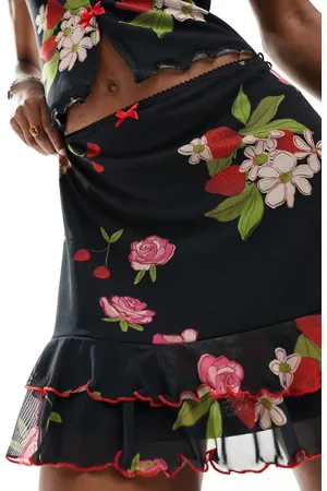 Reclaimed Mini skirt with bows in black vintage floral and fruit print