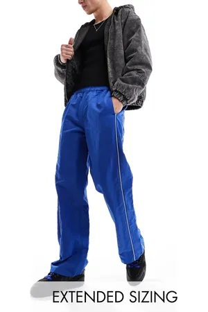 ASOS Baggy nylon track pants in with white piping