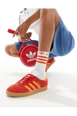 adidas Gazelle trainers in red and orange with gum sole