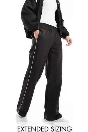 ASOS Baggy nylon track pants in with white piping