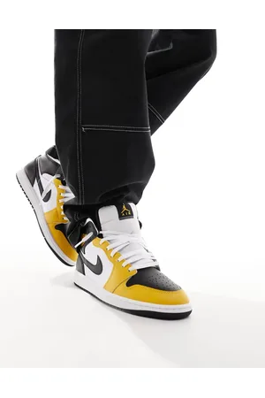 Jordan Air 1 Mid trainers in white and