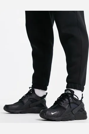 Nike Air Huarache trainers in black and metallic silver