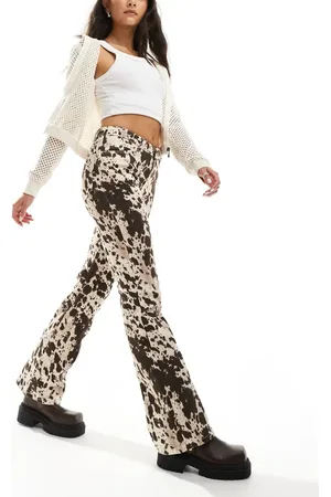 Monki Regular fit flare cotton trousers in cow print