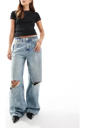 ASOS Mid rise baggy boyfriend jeans with rips and paint splats in mid