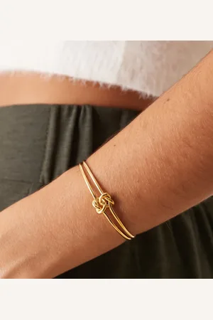 Orelia Polished interlocking knot bangle in 18k plated