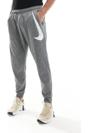 Nike Swoosh graphic tapered joggers in grey