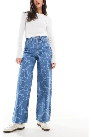 Threadbare Straight leg jeans with all over bow design in mid wash