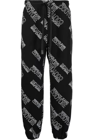 VERSACE All-over logo track pants