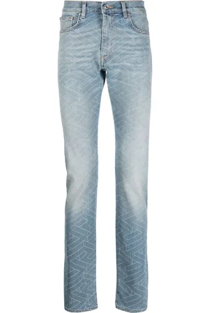 VERSACE Geometric-print washed jeans