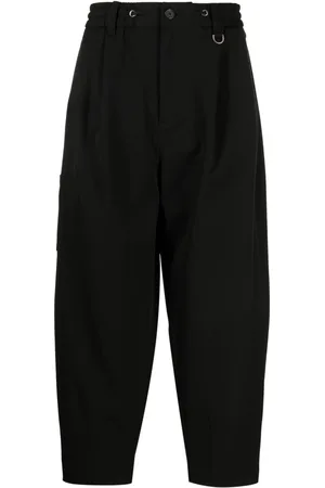 SONGZIO Logo-embroidered pleated drop-crotch trousers
