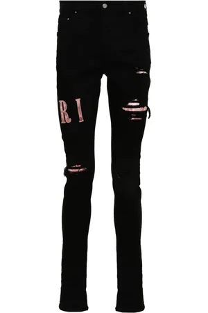 AMIRI Waxed logo-appliqué skinny jeans